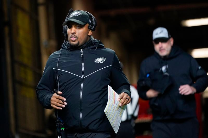Philadelphia Eagles offensive coordinator Brian Johnson jogs onto the field during halftime of an NFL football game against the Seattle Seahawks, Monday, Dec. 18, 2023, in Seattle. The Falcons on Thursday completed a virtual interview with Brian Johnson for their vacancy. (AP Photo/Lindsey Wasson)