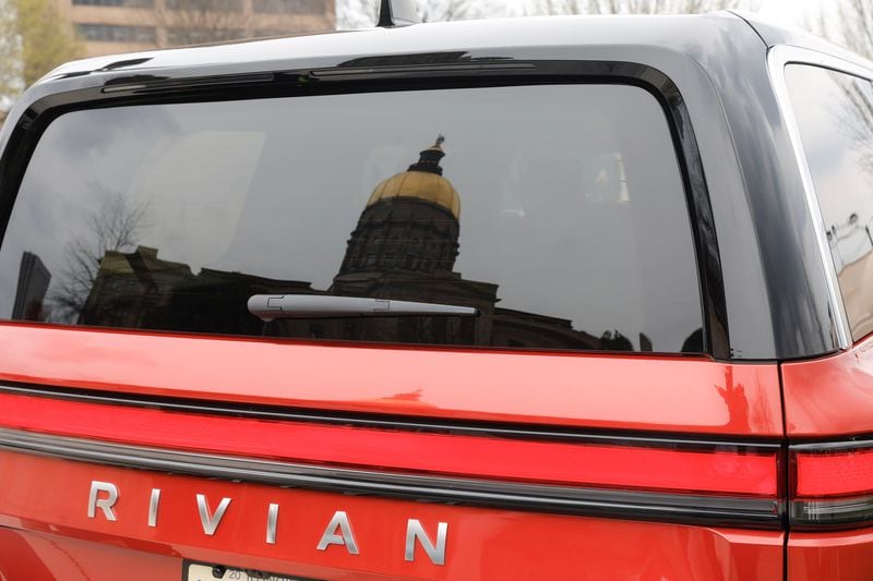 Views of the Georgia State Capitol reflected in the window of a Rivian electric vehicle on Wednesday, March 1, 2023. (Natrice Miller/The Atlanta Journal-Constitution/TNS)