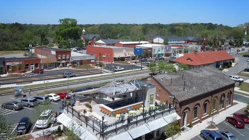 A project to continue improvements to South Main Street in downtown Woodstock will begin July 9 and go through next April, city officials say. AJC FILE