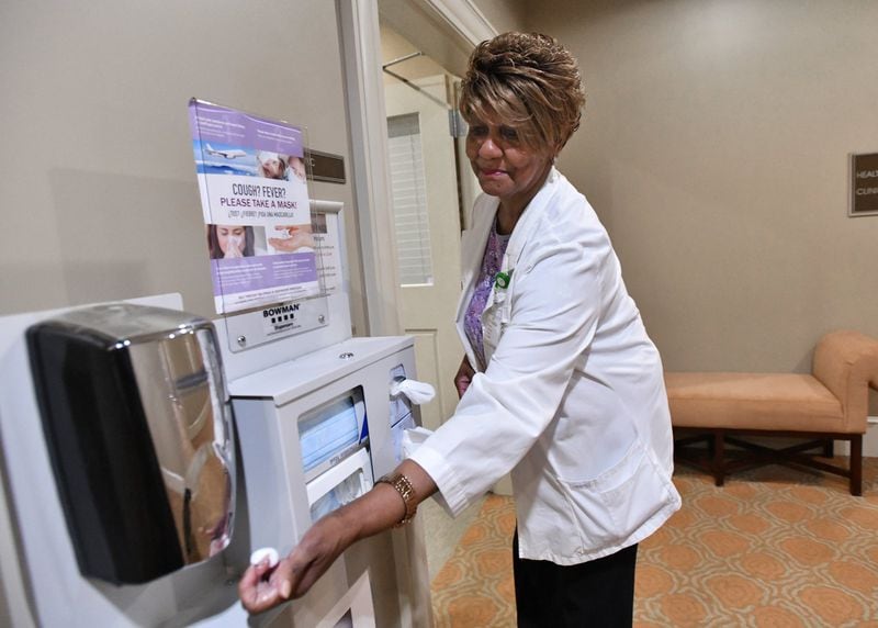 Lenbrook staffer Lonette Martin shows how to use hand sanitizer at the Atlanta home on Thursday. Following basic hygiene protocols is key to preventing coronavirus from spreading at long-term care homes, public health experts said. HYOSUB SHIN / HYOSUB.SHIN@AJC.COM