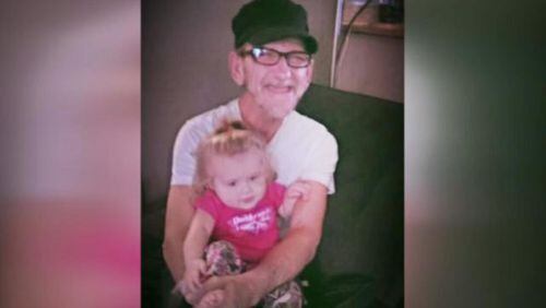 Dewey Edward Skidmore, seen with his granddaughter) was killed Sunday when someone ran him over and left tire tracks on his clothes. (Credit: Channel 2 Action News)