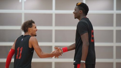 Hawks guard Trae Young celebrates with center Clint Capela during Monday, Sept. 28, 2020, training session at team's practice facility in Atlanta. Capela, who the Hawks acquired at the trade deadline, has not played since Jan. 29 because of a nagging heel injury.