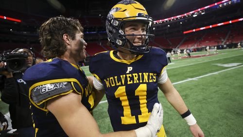 Prince Avenue Christian quarterback Aaron Philo (11) celebrates with teammates after their 49-32 win against Swainsboro in the Class A Division I GHSA State Championship game at Mercedes-Benz Stadium, Monday, December. 11, 2023, in Atlanta. (Jason Getz / Jason.Getz@ajc.com)
