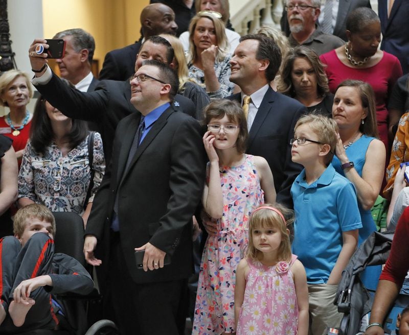 Families that use medical marijuana oil celebrated by taking a selfie as Gov. Brian Kemp signed a bill allowing marijuana cultivation and sales into law last month. Bob Andres / bandres@ajc.com