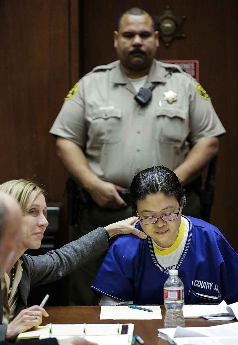 Defense attorney Tracy Green, left, comforts Dr. Hsiu-Ying "Lisa" Tseng, in 2015 as she is sentenced 30 years to life in prison. The California physician was convicted of second-degree murder in the overdose deaths of her patients.