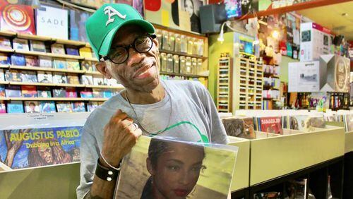 Darryl Harris, owner of Moods Music in Little Five Points, holds one of his favorite albums, Sade’s “Stronger Than Pride” while preparing for Record Store Day. (Photo Courtesy of Dyana Bagby)