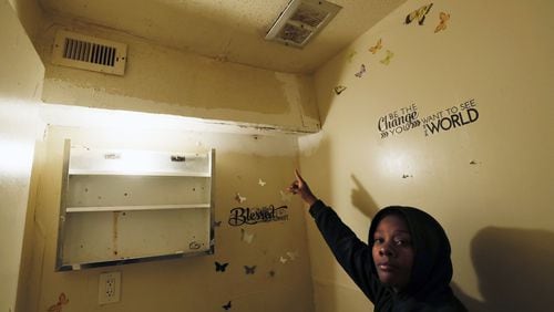 Forest Cove resident Madrika Gray shows where broken pipes leaked into her Atlanta apartment, damaging the walls and dripping water down through moldy vents. She and other tenants who have mold in their homes have no safety net in Georgia, where local and state laws do little to protect them. BOB ANDRES / BANDRES@AJC.COM