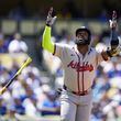 Atlanta Braves designated hitter Marcell Ozuna tosses his bat as he runs to first on a single during the fifth inning of a baseball game against the Los Angeles Dodgers in Los Angeles, Sunday, May 5, 2024. (AP Photo/Ashley Landis)