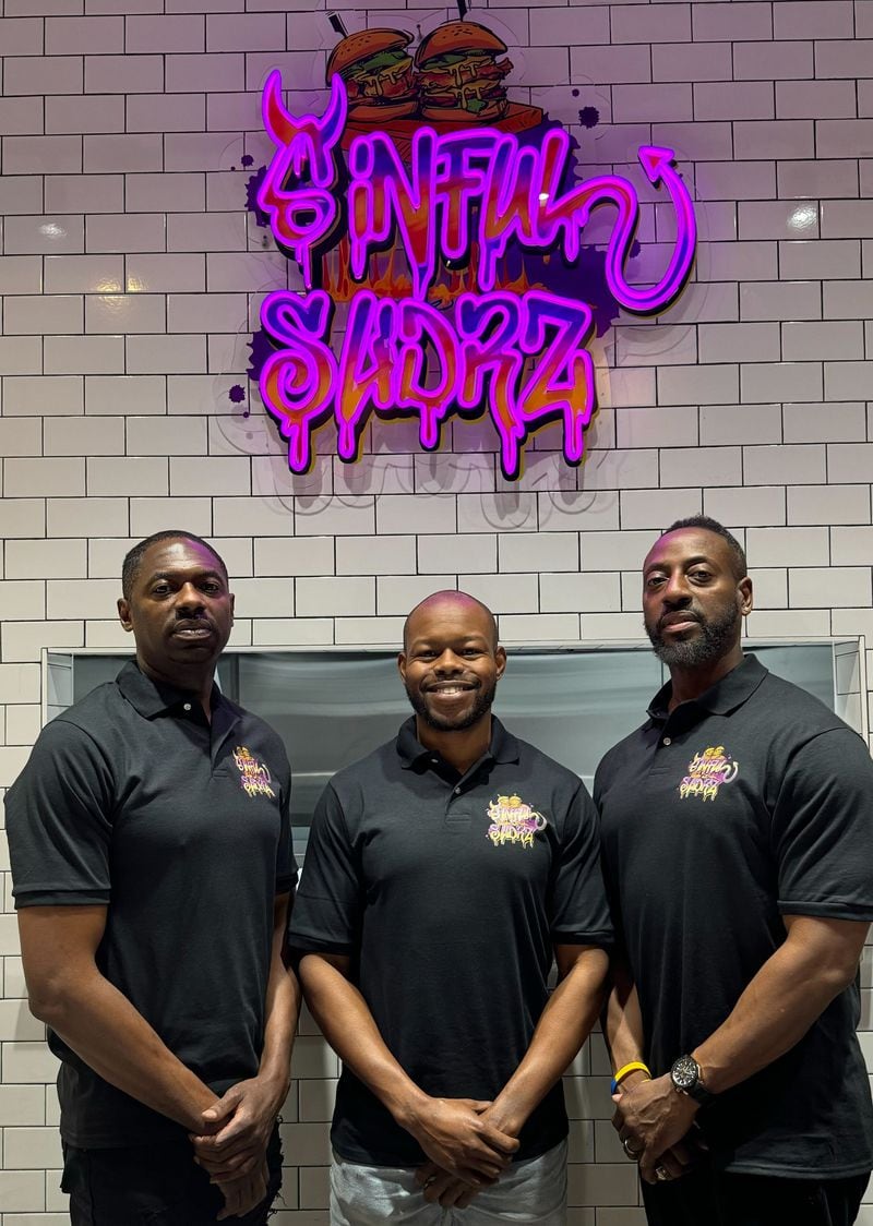 David Allen (from left), Rickey Beasley and Errol Buggs are behind the Sinful Slidrz stall in the Southern Feed Store food hall in East Atlanta. / Courtesy of Sinful Slidrz