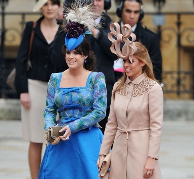 Weird hats, like those sported here by (l-r) Princess Eugenie and Princess Beatrice at William and Kate’s 2011 nuptials, are what makes a royal wedding must-see TV.