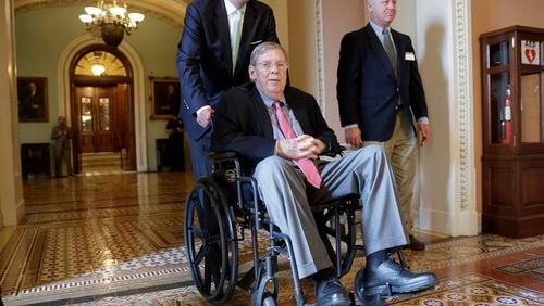 Sen. Johnny Isakson, R-Ga., who is recovering from back surgery, is wheeled away from the Senate chamber on Capitol Hill in Washington, Thursday, March 30, 2017, following a vote to advance legislation that would allow states to block federal family-planning funds to Planned Parenthood. (AP Photo/J. Scott Applewhite)