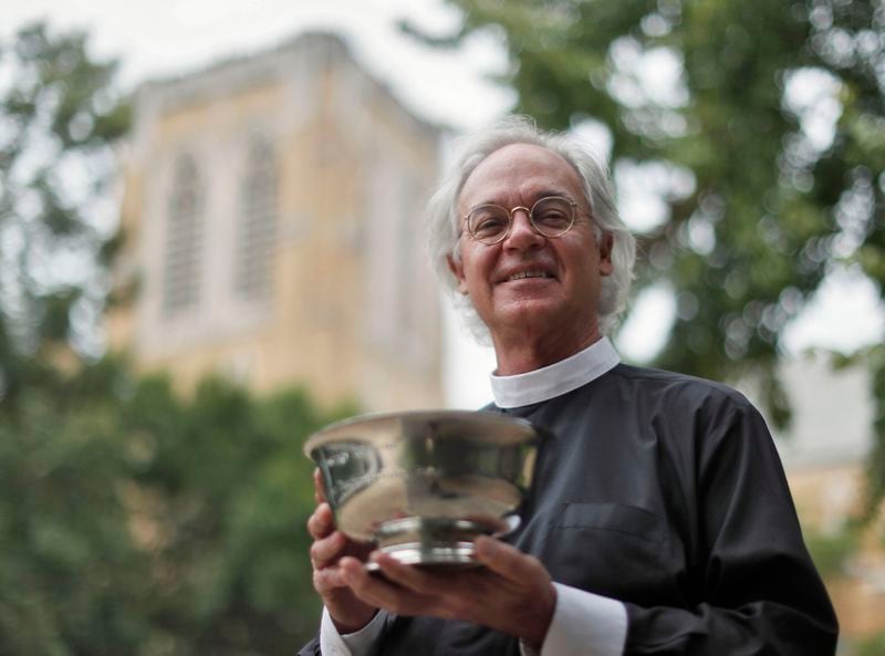 June 26, 2019 -  Atlanta -  For a couple of decades, Rev. Samuel Candler of the The Cathedral of St. Philip blesses AJC Peachtree Road Race runners with holy water.   He's doing the invocation at the start of this year's race.    Bob Andres / bandres@ajc.com