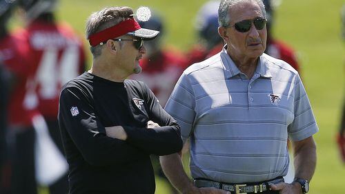 Atlanta Falcons owner Arthur Blank, right, talks with general manager Thomas Dimitroff during NFL minicamp football Thursday, June 15, 2017, in Flowery Branch, Ga. (AP Photo/John Bazemore)