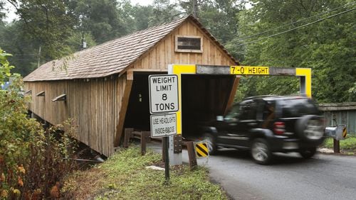 Traffic makes its way through the Concord Covered Bridge over Nickajack Creek, a historic covered bridge that was entered into the the National Register of Historic Places in 1980, in this AJC file photo. BOB ANDRES /BANDRES@AJC.COM
