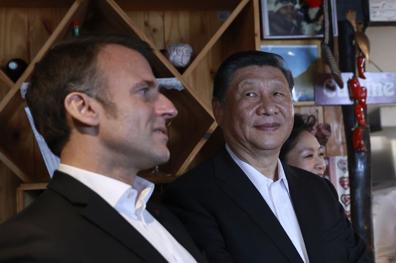 Chinese President Xi Jinping, right, watches French President Emmanuel Macron in a restaurant, Tuesday, May 7, 2024 at the Tourmalet pass, in the Pyrenees mountains. French president is hosting China's leader at a remote mountain pass in the Pyrenees for private meetings, after a high-stakes state visit in Paris dominated by trade disputes and Russia's war in Ukraine. French President Emmanuel Macron made a point of inviting Chinese President Xi Jinping to the Tourmalet Pass near the Spanish border, where Macron spent time as a child visiting his grandmother. (AP Photo/Aurelien Morissard, Pool)