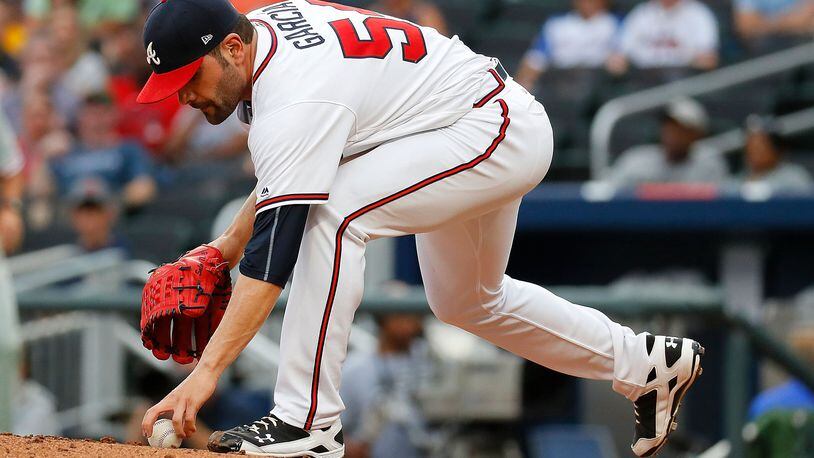 Braves starter Jaime Garcia picks up a grounder hit to him by Howie Kendrick of the Phillies during Tuesday&#039;s game.