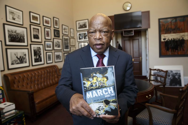 In 2013, John Lewis became a comic book author with the publication of "MARCH: Book One," the first of a three-part autobiography of his time in the civil rights movement. Parts Two (pictured) and Three were published in 2015 and 2016, respectively. The graphic novels were co-written by Andrew Aydin and illustrated by Nate Powell. Among the trilogy's many awards, Part Three won a National Book Award for young people's literature. (J. Scott Applewhite / AP)