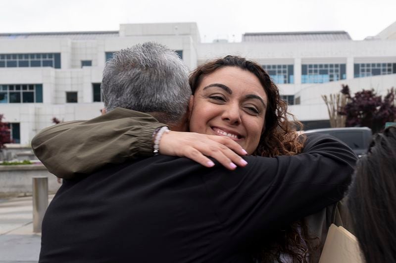 Marina Hernandez hugs her stepfather Leoncio Romero on Tuesday after charges were announced in her daughter's death.