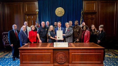 Gov. Brian Kemp recognized Cobb firefighters, two residents and an ambulance service for saving the life of a man who went into cardiac arrest.