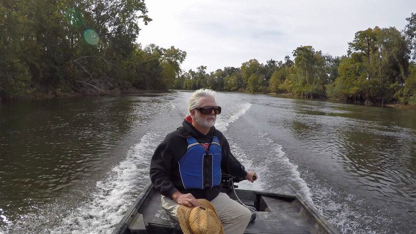 Gordon Rogers, Riverkeeper and Executive Director of Flint Riverkeeper, drives a boat on the Flint River near the Decatur/Mitchell County line in 2019. Rogers says that on the Flint, "you’re seeing so much biology, so much life right in front of your face, that it’s just stunning.” (Hyosub Shin / Hyosub.Shin@ajc.com)