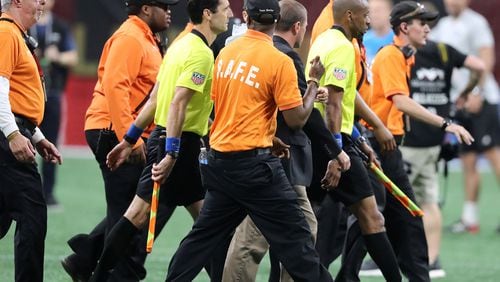 May 9, 2018 Atlanta: Security guards escort the game officials off the field after a heated match between Atlanta United and Sporting Kansas City in a MLS soccer match on Wednesday, May 9, 2018, in Atlanta.  Curtis Compton/ccompton@ajc.com