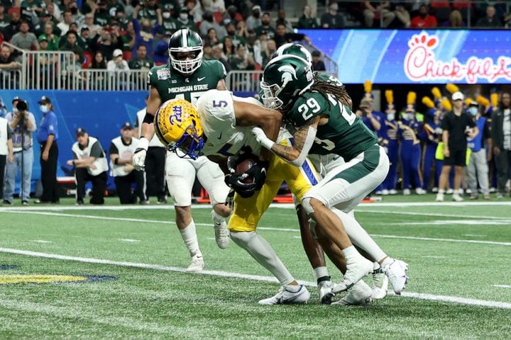 Pittsburgh Panthers wide receiver Jared Wayne (5) scores a receiving touchdown against Michigan State Spartans cornerback Marqui Lowery (29) during the first half of the Chick-fil-A Peach Bowl at Mercedes-Benz Stadium in Atlanta, Thursday, December 30, 2021. JASON GETZ FOR THE ATLANTA JOURNAL-CONSTITUTION