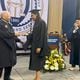 Ronald Yancey, who became the first Black person to graduate from Georgia Tech in 1965, hands a diploma to his granddaughter, Deanna Yancey, during a commencement ceremony on Friday, May 3, 2024. (Courtesy of Georgia Tech)