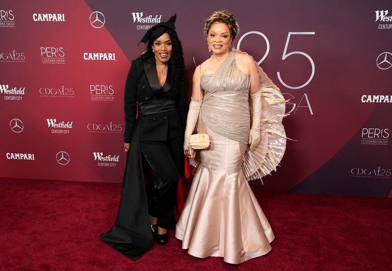 Spotlight Award honoree Angela Bassett, left, a cast member in "Black Panther: Wakanda Forever," poses with the film's costume designer Ruth E. Carter at the 25th Costume Designers Guild Awards, Monday, Feb. 27, 2023, in Los Angeles. (AP Photo/Chris Pizzello)