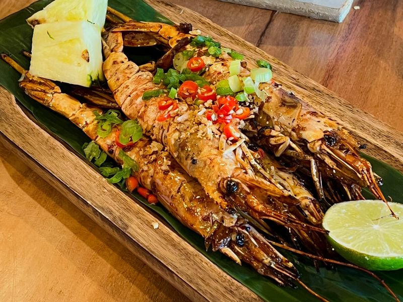 Whole grilled prawns at Kamayan are gorgeous, but it's a messy, process to get to the tender tail meat. Henri Hollis/henri.hollis@ajc.com