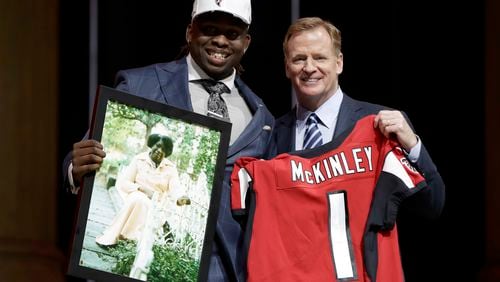 UCLA's Takkarist McKinley, left, poses with NFL commissioner Roger Goodell after being selected by the Atlanta Falcons during the first round of the 2017 NFL football draft, Thursday, April 27, 2017, in Philadelphia.