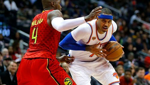 New York Knicks forward Carmelo Anthony (7) drives to the basket as Atlanta Hawks forward Paul Millsap (4) defends in the second half of an NBA basketball game on Sunday, Jan. 29, 2017, in Atlanta. The Hawks won the game in the fourth overtime. (AP Photo/Todd Kirkland)