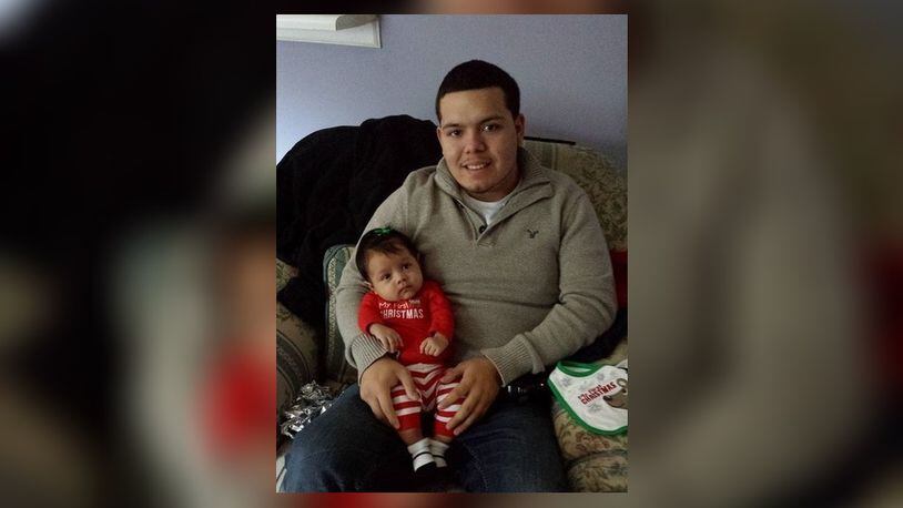 Daniel Perez, pictured with his son, was shot while sitting in a pickup truck Friday. The 25-year-old's family says he is brain dead.