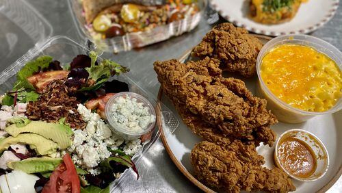 This takeout dinner from Joy Cafe includes: Cobb salad; fried chicken; salmon and lentil salad; and green-tomato tarts in the background. Wendell Brock for The Atlanta Journal-Constitution