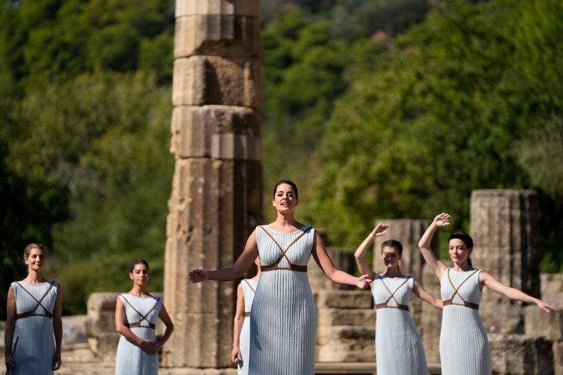 FILE - Greek actress Xanthi Georgiou, playing the role of the High Priestess, prays to the ancient God Apollo during the lighting of the Olympic flame at Ancient Olympia site, birthplace of the ancient Olympics in southwestern Greece, Oct. 18, 2021. On Tuesday, April 16, 2024 the flame for this summer's Paris Olympics will be lit and be carried through Greece for more than 5,000 kilometers (3,100 miles) before being handed over to French organizers at the Athens site of the first modern Olympics. (AP Photo/Thanassis Stavrakis, File)