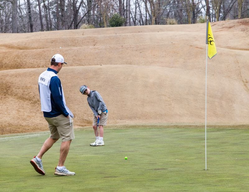 Ryan Rivera and his son, 6-year-old Parker, work the links during a U.S. Kids Golf tournament at Chattahoochee Golf Club near Gainesville on Saturday, Feb 27.  Parker finished 4th place and took home a medal.  (Jenni Girtman for The Atlanta Journal-Constitution)