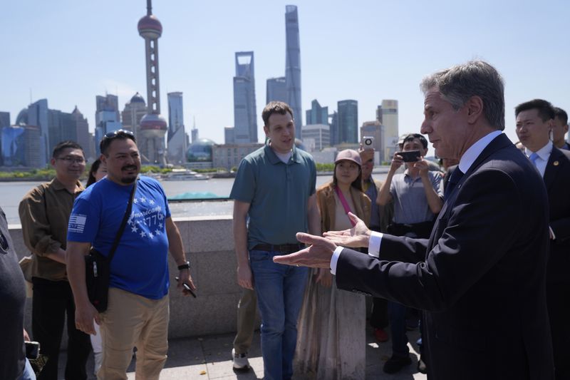 U.S. Secretary of State Antony Blinken, right, talks with U.S. tourists as he walks in a waterfront area called The Bund, Thursday, April 25, 2024, in Shanghai, China. (AP Photo/Mark Schiefelbein, Pool)