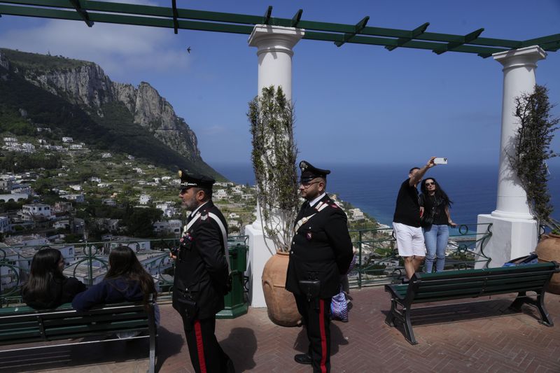 Italian Carabinieri paramilitary policemen patrol in downtown Capri, Wednesday, April 17, 2024. Group of Seven foreign ministers are meeting on the Italian resort island of Capri, with soaring tensions in the Mideast and Russia's continuing war in Ukraine topping the agenda. The meeting runs April 17-19. (AP Photo/Gregorio Borgia)