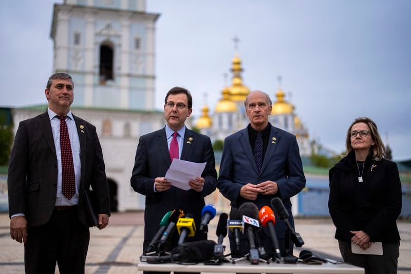 From left, U.S. representatives Nathaniel Moran, R-Tx, Tom Kean Jr, R-NJ, Bill Keating, D-Mass, and Madeleine Deane, D-Pa, talk to journalists during a joint news conference outside Saint Michael cathedral in Kyiv, Ukraine, Monday, April 22, 2024. A newly approved package of $61 billion in U.S. aid may prevent Ukraine from losing its war against Russia. But winning it will be a long slog. (AP Photo/Francisco Seco)