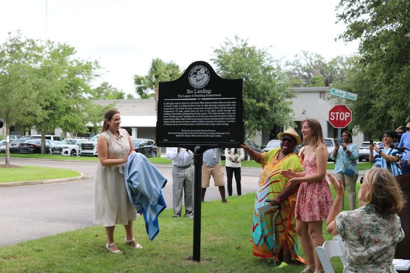Elyse Butler (from left), marker manager at the Georgia Historical Society; Amy Roberts, executive director of the St. Simons African American Heritage Coalition; and Rachel Waters, president of the Glynn Academy Ethnology Club celebrate the installation of the historical marker erected last year on St. Simons Island to commemorate the Igbo rebellion. 
Courtesy of Georgia Historical Society