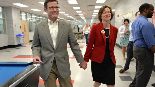 May 2, 2014 Atlanta - U.S. Senate candidate Michelle Nunn with her husband Ron Martin (left) leave after they voted early for the 2014 Primary at Adamsville Recreation Center in Atlanta on Friday, May 2, 2014. HYOSUB SHIN / HSHIN@AJC.COM U.S. Senate candidate Michelle Nunn with her husband Ron Martin (left) leave after they voted early for the 2014 Primary at Adamsville Recreation Center in Atlanta on last week. Hyosub Shin, hshin@ajc.com