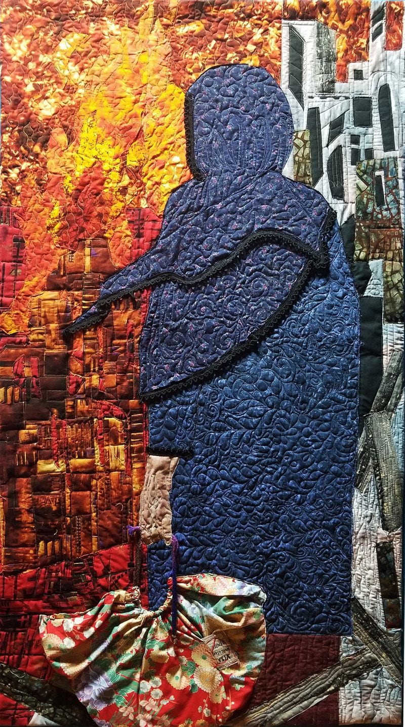 "Visa Denied," a quilt by Phyllis A. Cullen, Ninole, Hawaii, is included in the exhibit “Sacred Threads” at the Southeastern Quilt & Textile Museum in Carrollton. Courtesy of "Sacred Threads"