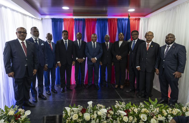 Interim Prime Minister Michel Patrick Boisvert, fifth from left, poses for a group photo with members of a transitional council tasked with selecting a new prime minister and cabinet, in Port-au-Prince, Haiti, Thursday, April 25, 2024. (AP Photo/Ramon Espinosa)