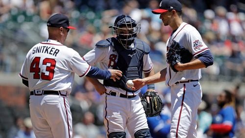 Atlanta Braves' Brian Snitker (43) takes the game ball from Charlie Morton in the fifth inning of a baseball game against the Toronto Blue Jays Thursday, May 13, 2021, in Atlanta. (AP Photo/Ben Margot)