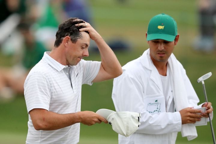 April 9, 2021, Augusta: Rory McIlroy and his caddie Harry Diamond walk off of the eighteenth green after McIlroyÕs second round during the Masters at Augusta National Golf Club on Friday, April 9, 2021, in Augusta. Curtis Compton/ccompton@ajc.com