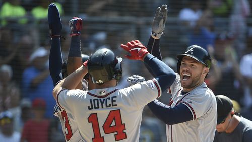 Braves' Freddie Freeman (right) is congratulated by Matt Joyce and Ronald Acuna (left) after hitting a three-run home run during the eighth inning July 14, 2019, against the San Diego Padres at Petco Park in San Diego.