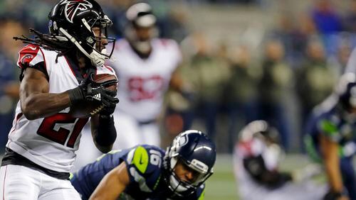 Falcons' Desmond Trufant runs with the ball after intercepting Seahawks quarterback Russell Wilson Monday, Nov. 20, 2017, in Seattle.