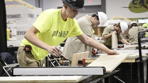 Banks Hathcox, 16, left, competes against other schools as he represents his school, Calhoun High School, during the SkillsUSA State Championship, Friday March 23, 2018, at the Georgia International Convention Center, March 23, 2018. (John Amis)