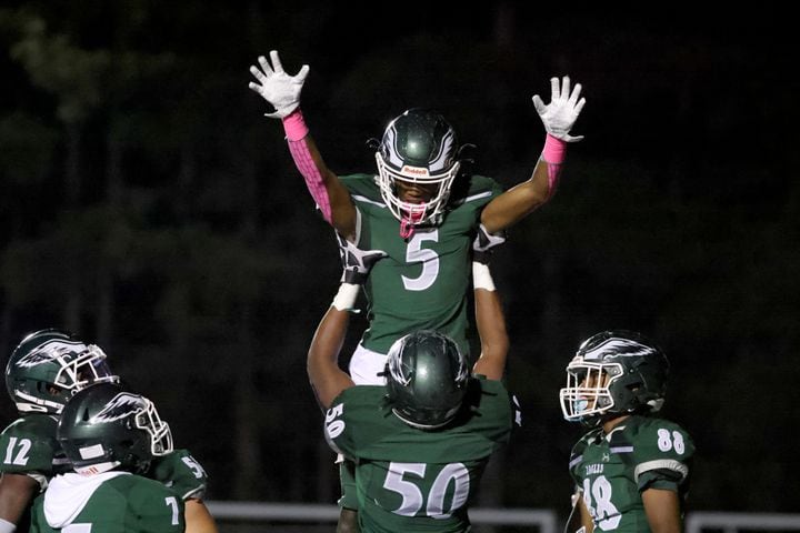 Collins Hill wide receiver Sean Norris (5) celebrates a touchdown with offensive lineman Cedric Richardson (50) in the first half against North Gwinnett at Collins Hill High School Friday, October 30, 2020 in Suwanee, Ga. JASON GETZ FOR THE ATLANTA JOURNAL-CONSTITUTION