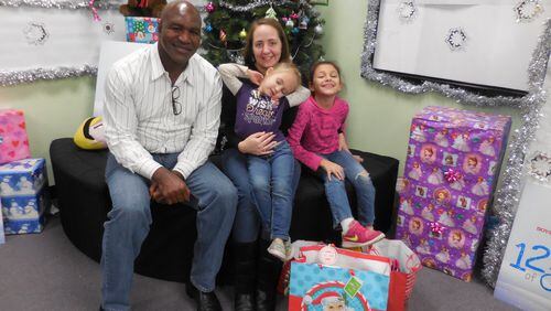 Evander Holyfield brought Christmas cheer to a family in need. Photo: Jennifer Brett, jbrett@ajc.com