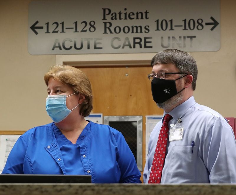 Elbert Memorial Hospital CEO Kerry Trapnell, right, confers with chief clinical officer Tammy Harlow in the acute care unit. The hospital is running out of rooms for patients from the recent surge. (Curtis Compton ccompton@ajc.com)